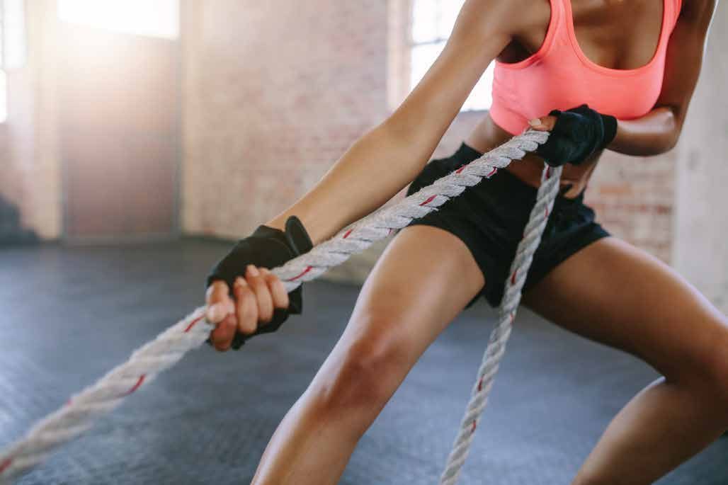 Athlete pulling battle ropes during a strength session