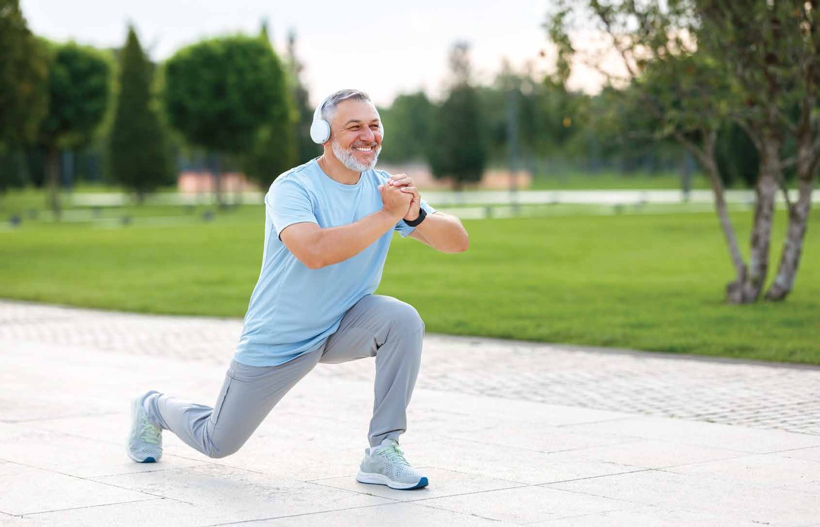 Senior client doing a lunge outdoors